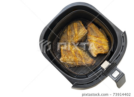 Deep fried fish in tray of hot air fryer or oil-free fryer, top view image, isolated on white background. The concept for modern and healthy cooking. The fried fish is Snakeskin gourami fish. Deep fried fish in tray of hot air fryer or oil-free fryer, top view image, isolated on white background. The concept for modern and healthy cooking. The fried fish is Snakeskin gourami fish. 73914402