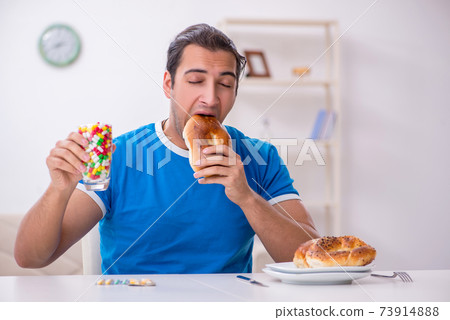 Young hungry man in dieting concept 73914888