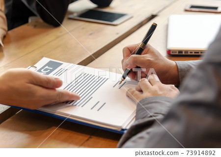 Close up hand businessman signing a contract legal for start up new project for investment. Close up hand businessman signing a contract legal for start up new project for investment. 73914892