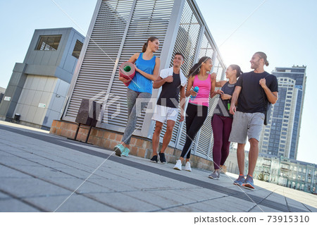 Happy young multiracial sport team going to workout Happy young multiracial sport team going to workout 73915310