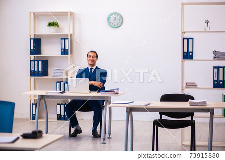 Young male employee working in the office Young male employee working in the office 73915880