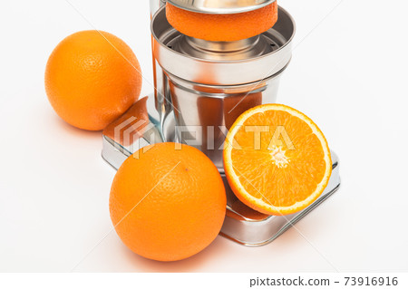 juicer with oranges on white background juicer with oranges on white background 73916916