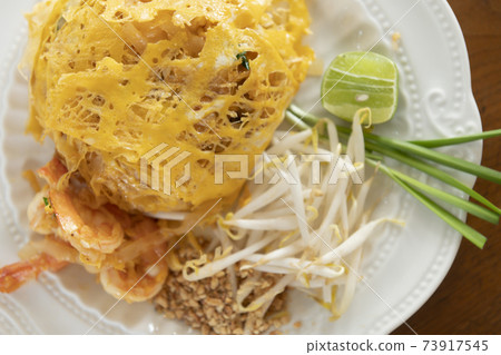 Pad Thai wrapped in egg, picture from top corner Pad Thai wrapped in egg, picture from top corner 73917545