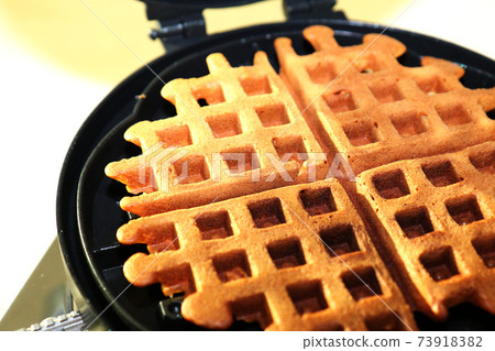 Handmade American waffles with a waffle maker for open fire 73918382