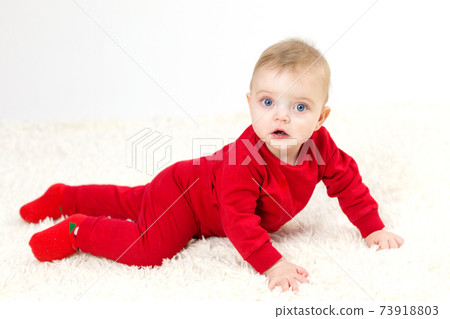 Small child in red clothes crawls on the floor Small child in red clothes crawls on the floor 73918803