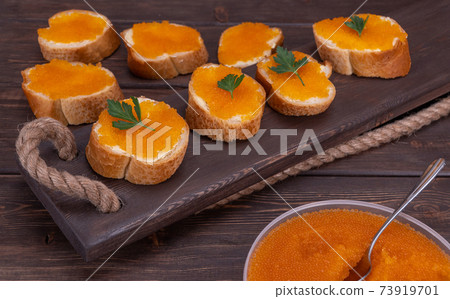 sandwiches with red caviar. selective focus. valuable food product, has high taste qualities sandwiches with red caviar. selective focus. valuable food product, has high taste qualities 73919701