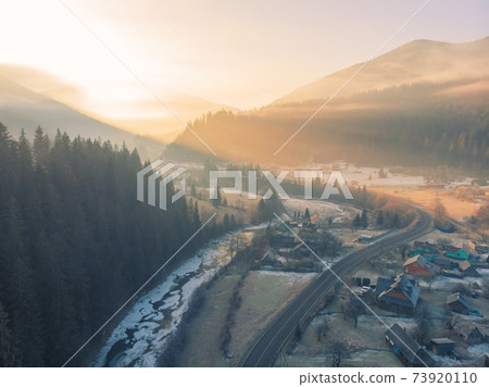 Mountain Village in the Morning. Aerial Shot of Majestic Sunrise in a Valley at Foggy Morning Mountains Landscape. Fir Tops and Cozy Houses in Carpathians, Tatariv, Ukraine, Europe 73920110