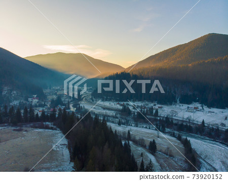 Mountain Village in the Morning. Aerial Shot of Majestic Sunrise in a Valley at Foggy Morning Mountains Landscape. Fir Tops and Cozy Houses in Carpathians, Tatariv, Ukraine, Europe 73920152