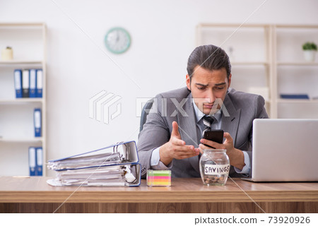 Young male employee in pension concept at workplace 73920926