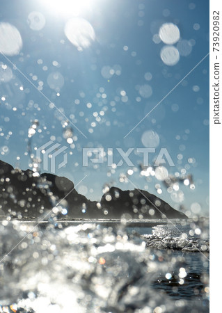 Waves breaking on the coast, spray, white water and light reflected on the surface of the water Waves breaking on the coast, spray, white water and light reflected on the surface of the water 73920982