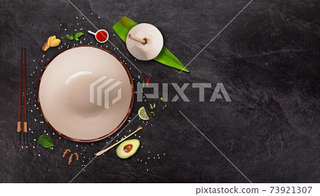 Asian ingredients served on black stone table. 73921307