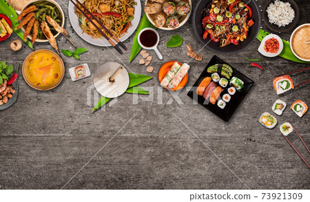 Asian food served on black stone table, top view, space for text. 73921309