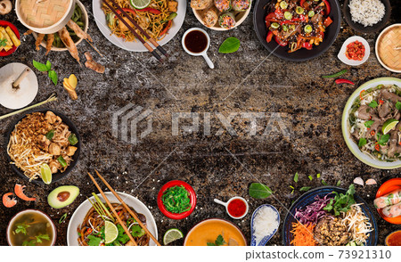 Asian food served on black stone table, top view, space for text. 73921310