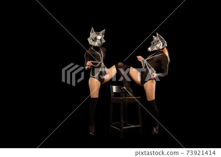 Two go-go variety show dancers in wolf masks on black Two go-go variety show dancers in wolf masks on black 73921414