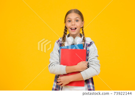 small happy kid in earphones with notepad. child ready small happy kid in earphones with notepad. child ready 73922144