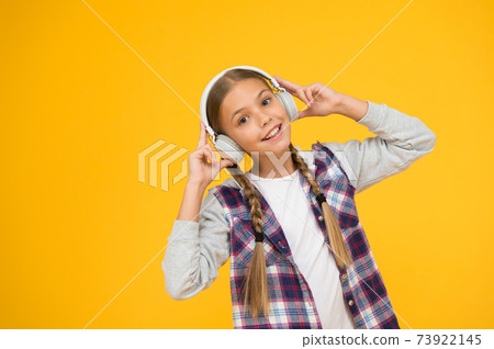 Happy little girl wearing modern headphones. Cute kid Happy little girl wearing modern headphones. Cute kid 73922145