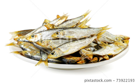 Smoked small fish on a plate on a white background. Isolated Smoked small fish on a plate on a white background. Isolated 73922193