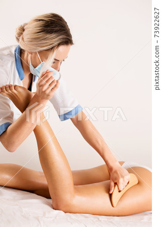 Anti-cellulite massage with wooden tool blade Anti-cellulite massage with wooden tool blade 73922627