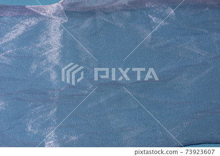 Blue shiny organza fabric close up. Abstract background. Blue shiny organza fabric close up. Abstract background. 73923607