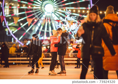 Ice skating together. Romantic winter vacation in ice arena. Young couple skating at ice rink. Best Christmas ever. Winter fun. Cute Valentine's Day. New Year with couple on skating. winter holidays Ice skating together. Romantic winter vacation in ice arena. Young couple skating at ice rink. Best Christmas ever. Winter fun. Cute Valentine's Day. New Year with couple on skating. winter holidays 73924320
