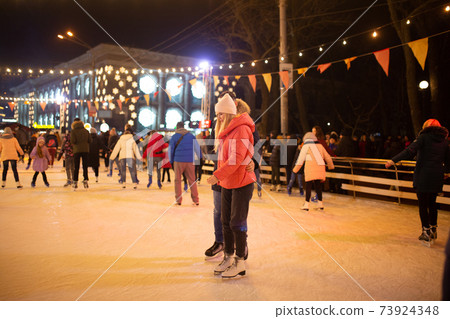 Ice skating together. Romantic winter vacation in ice arena. Young couple skating at ice rink. Best Christmas ever. Winter fun. Cute Valentine's Day. New Year with couple on skating. winter holidays Ice skating together. Romantic winter vacation in ice arena. Young couple skating at ice rink. Best Christmas ever. Winter fun. Cute Valentine's Day. New Year with couple on skating. winter holidays 73924348