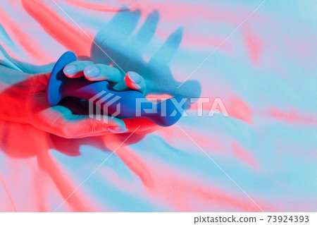 Woman holding anal balls in bed close-up. 73924393