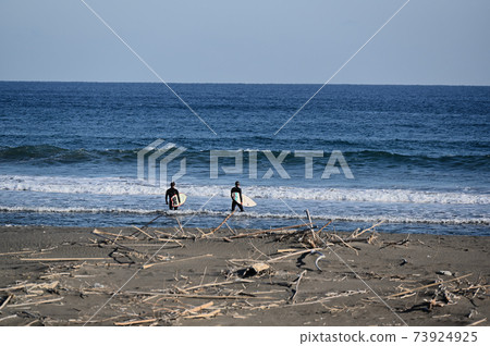 Surfers entering the winter sea Surfers entering the winter sea 73924925