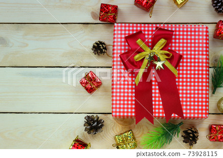Christmas gift box on the wooden floor. Christmas gift box on the wooden floor. 73928115