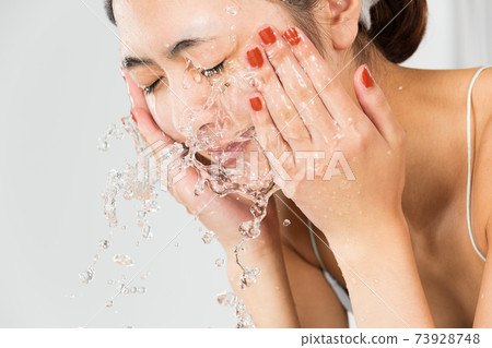 Women washing their face Women washing their face 73928748