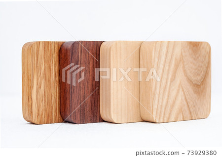 Assortment of wood handcraft pieces in row on white background 73929380