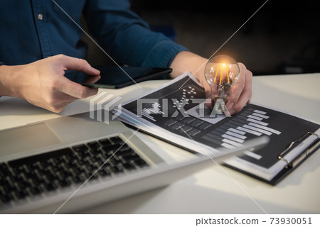 Business man holding light bulbs, ideas of new ideas with innovative technology and creativity in office. Business man holding light bulbs, ideas of new ideas with innovative technology and creativity in office. 73930051