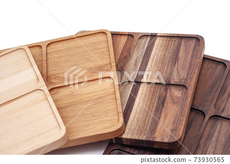 Shaped wooden trays in row on white background Shaped wooden trays in row on white background 73930565