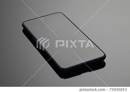 Black large screen smartphone with shadow on glass 73930853