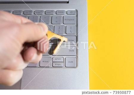 man using contactless tool to press button and prevent spread of Covid. man using contactless tool to press button and prevent spread of Covid. 73930877