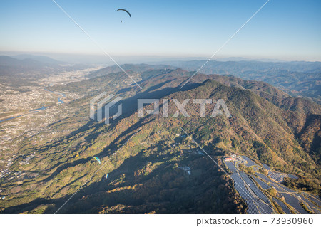 Aerial view of a paraglider flying near Mt. Ryumon in Kinokawa City, Wakayama Prefecture 73930960