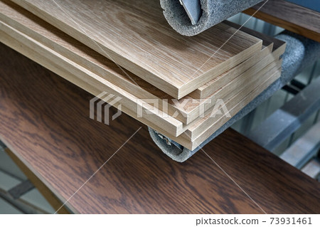Stacked oak veneer panels in a spray booth. Production of wood furniture. Furniture manufacture. Stacked oak veneer panels in a spray booth. Production of wood furniture. Furniture manufacture. 73931461