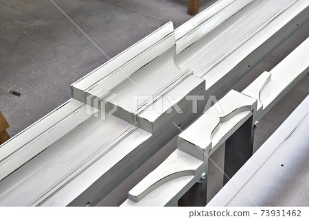 Joinery. Crown molding of a classic wardrobe. Production of wood furniture. Furniture manufacture. Close-up Joinery. Crown molding of a classic wardrobe. Production of wood furniture. Furniture manufacture. Close-up 73931462