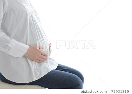 Pregnant woman sitting and relaxing 73931819