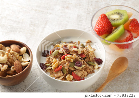Breakfast of yogurt-poured cereal, fruits and nuts 73932222