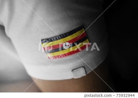 Patch of the national flag of the Uganda on a white t-shirt Patch of the national flag of the Uganda on a white t-shirt 73932944