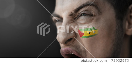 A screaming man with the image of the Sao Tome and Principe national flag on his face A screaming man with the image of the Sao Tome and Principe national flag on his face 73932973