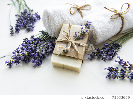 Spa setting with natural soap, towels and lavender.. 73933669