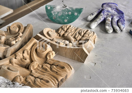 Joinery. Preparation wooden carved capital for painting in painting chamber. Furniture manufacture Joinery. Preparation wooden carved capital for painting in painting chamber. Furniture manufacture 73934083