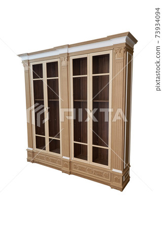Bookcase. Mdf cabinet carcass with moldings and wooden carved capital on a white background. Work in progress Bookcase. Mdf cabinet carcass with moldings and wooden carved capital on a white background. Work in progress 73934094