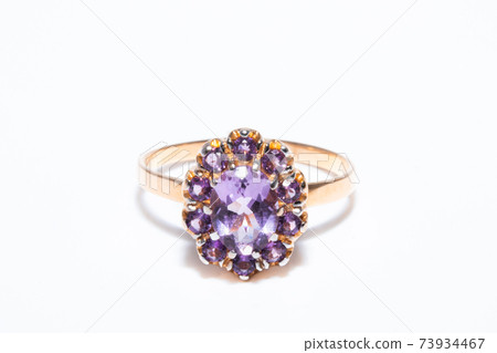 Beautiful golden ring with purple gemstone isolated on white background 73934467