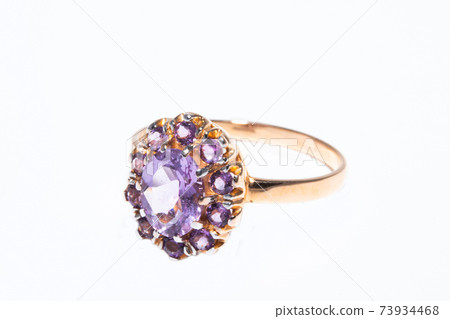 Beautiful golden ring with purple gemstone isolated on white background 73934468