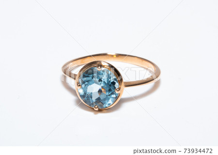 Beautiful old golden ring with blue gemstone isolated on white background Beautiful old golden ring with blue gemstone isolated on white background 73934472