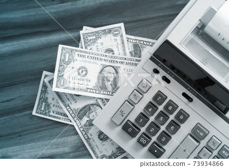 Old fashioned calculator and dollars 73934866