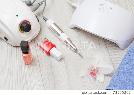 Set of cosmetic tools on a gray wooden background. 73935262
