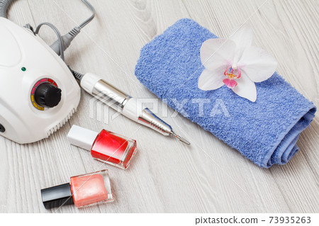 Set of cosmetic tools on a gray wooden background. 73935263